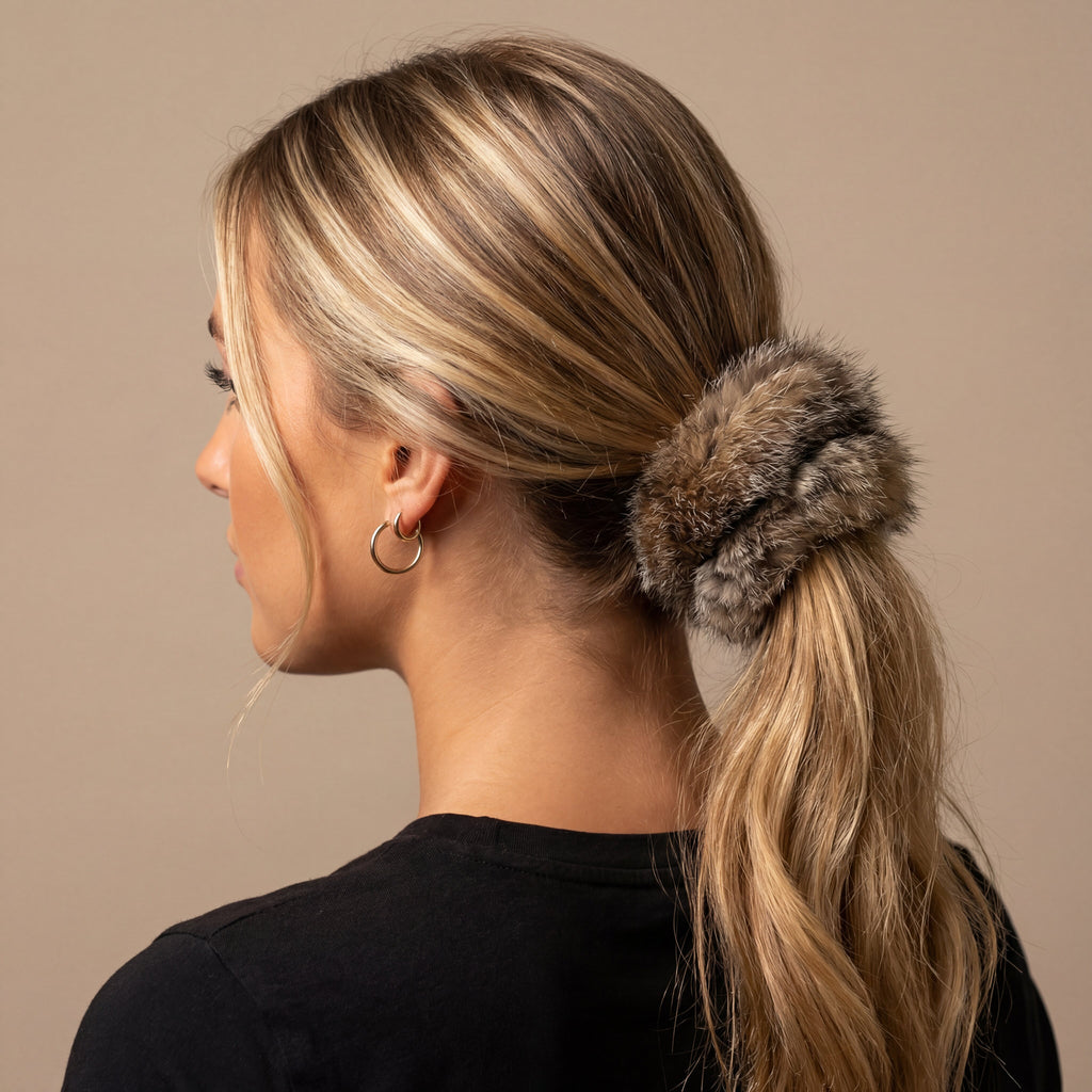 grey fox fur scrunchie holding up someones hair