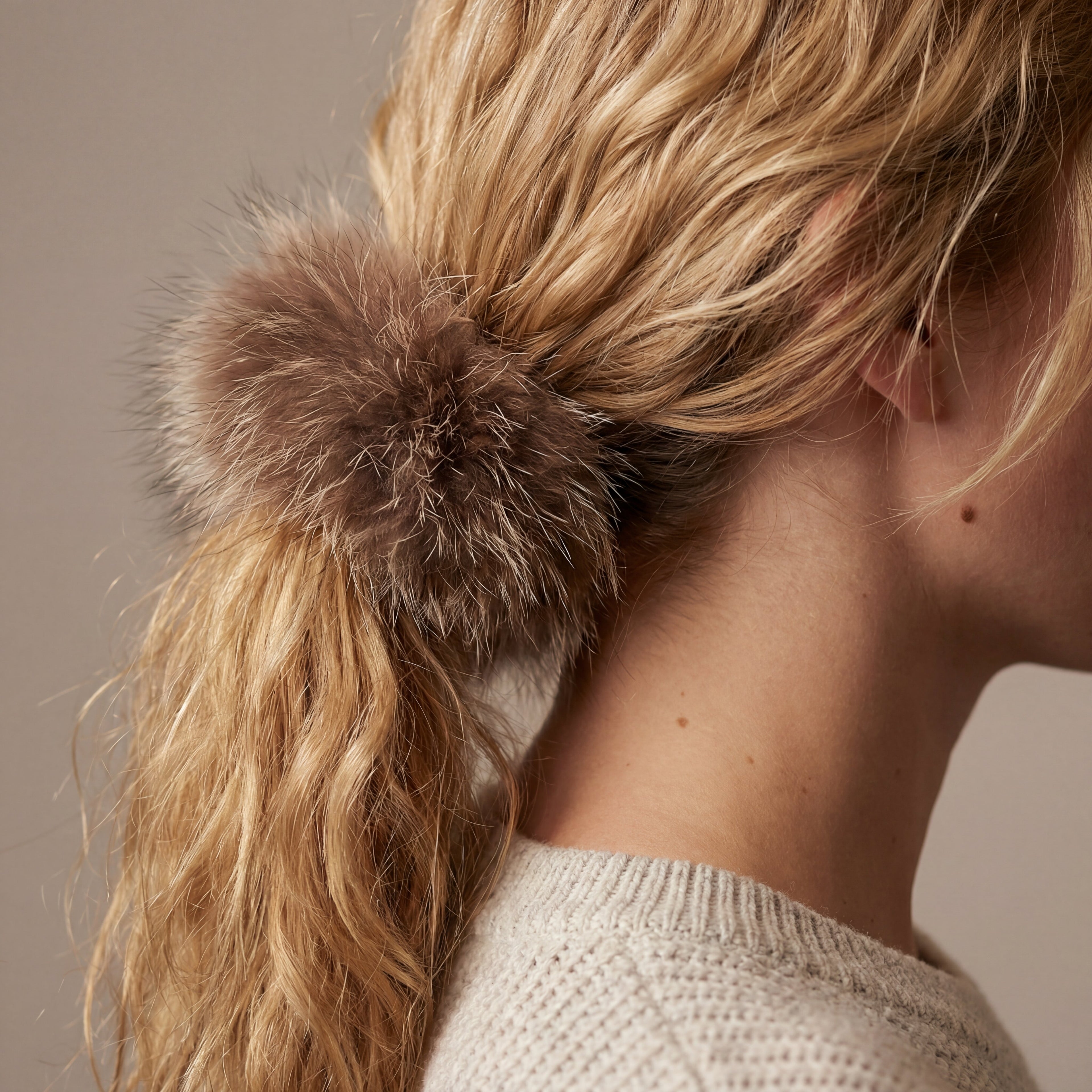 raccoon fur hair scrunchie holding up someones hair