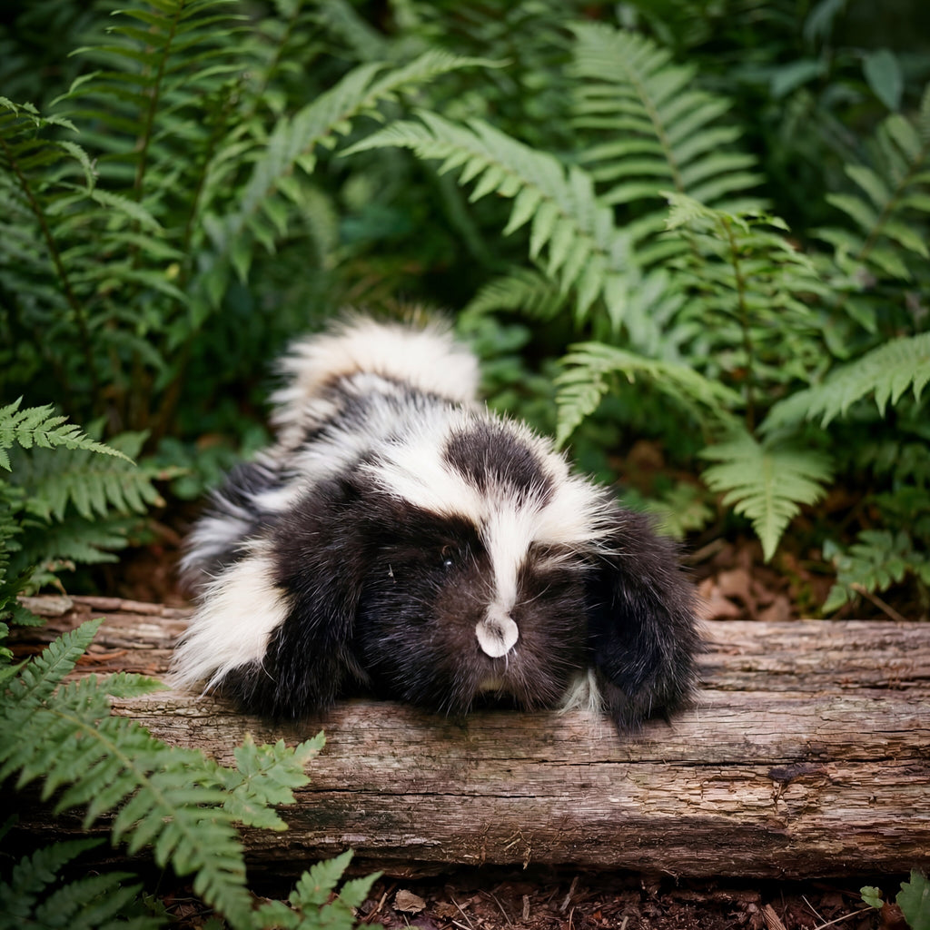 skunk fur hound puppy outside on a log